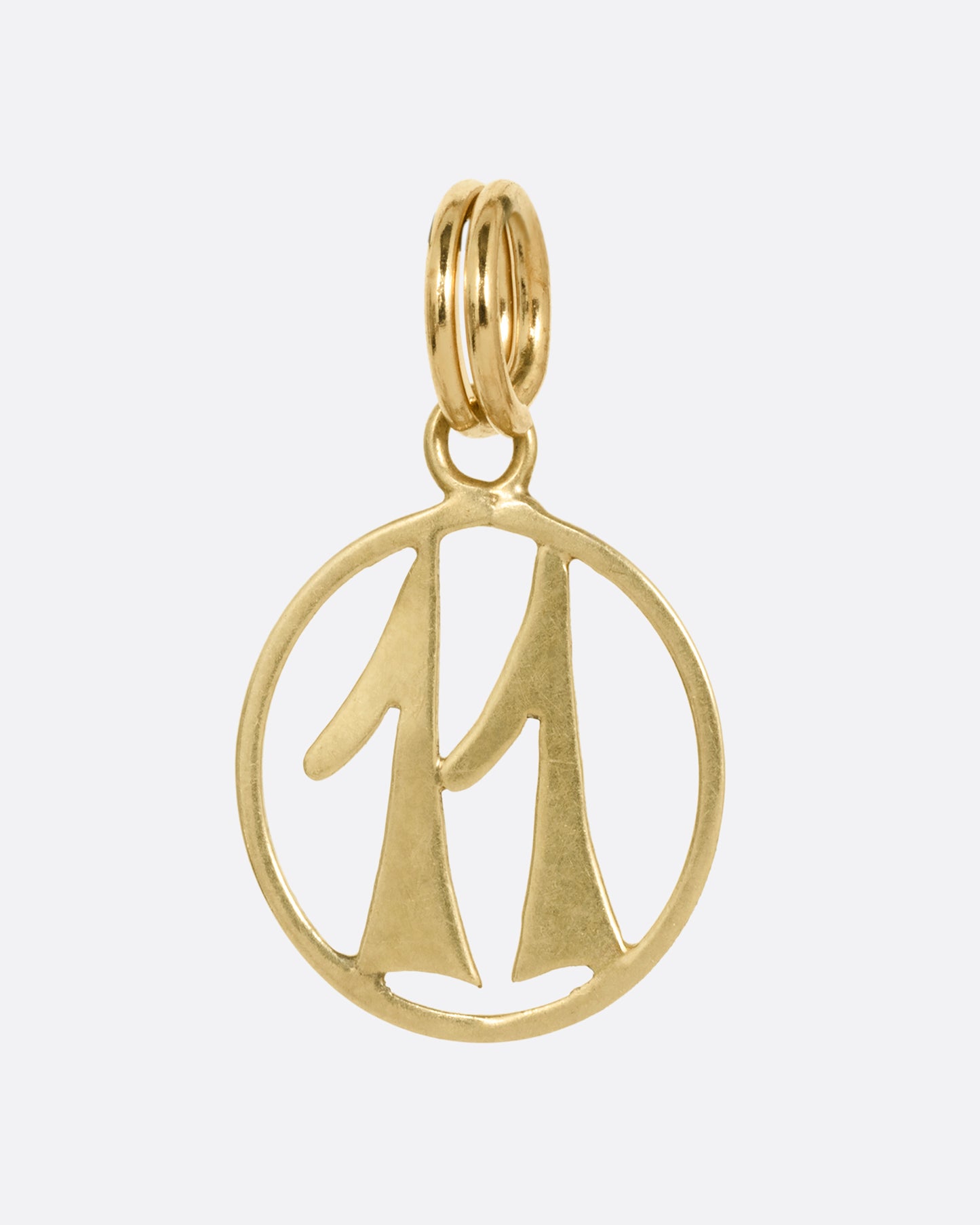 An open round yellow gold '11' pendant, shown from the front.