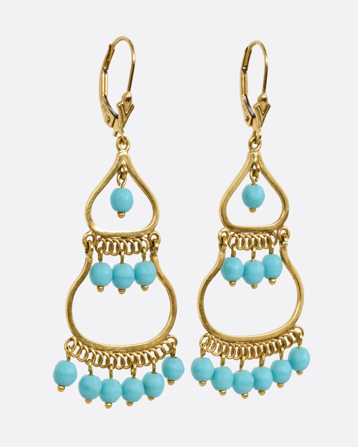 A pair of yellow gold drop chandelier earrings with turquoise beads, shown from the side.