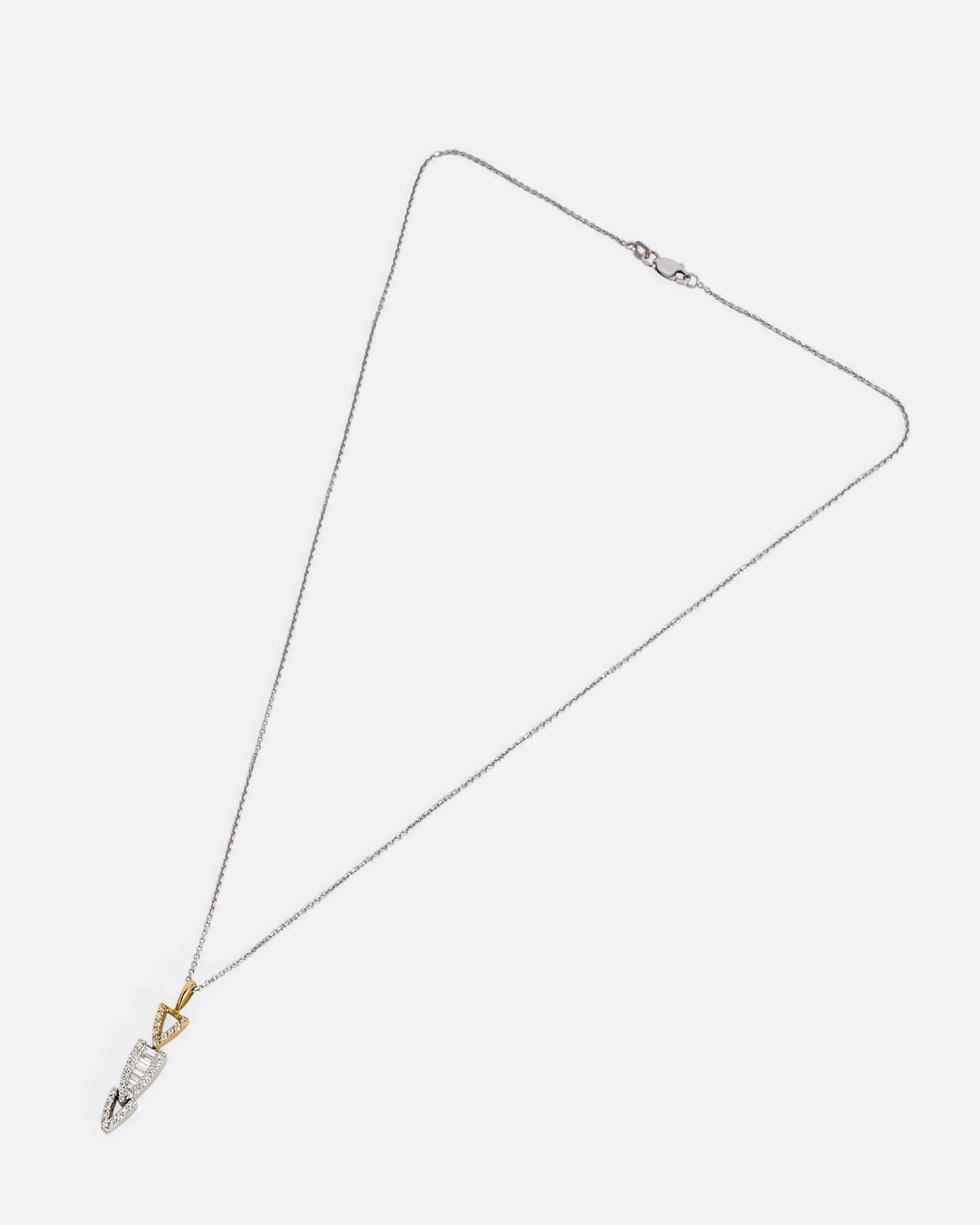 A white gold cable chain necklace with a diamond studded stack of arrows. Shown from the front.