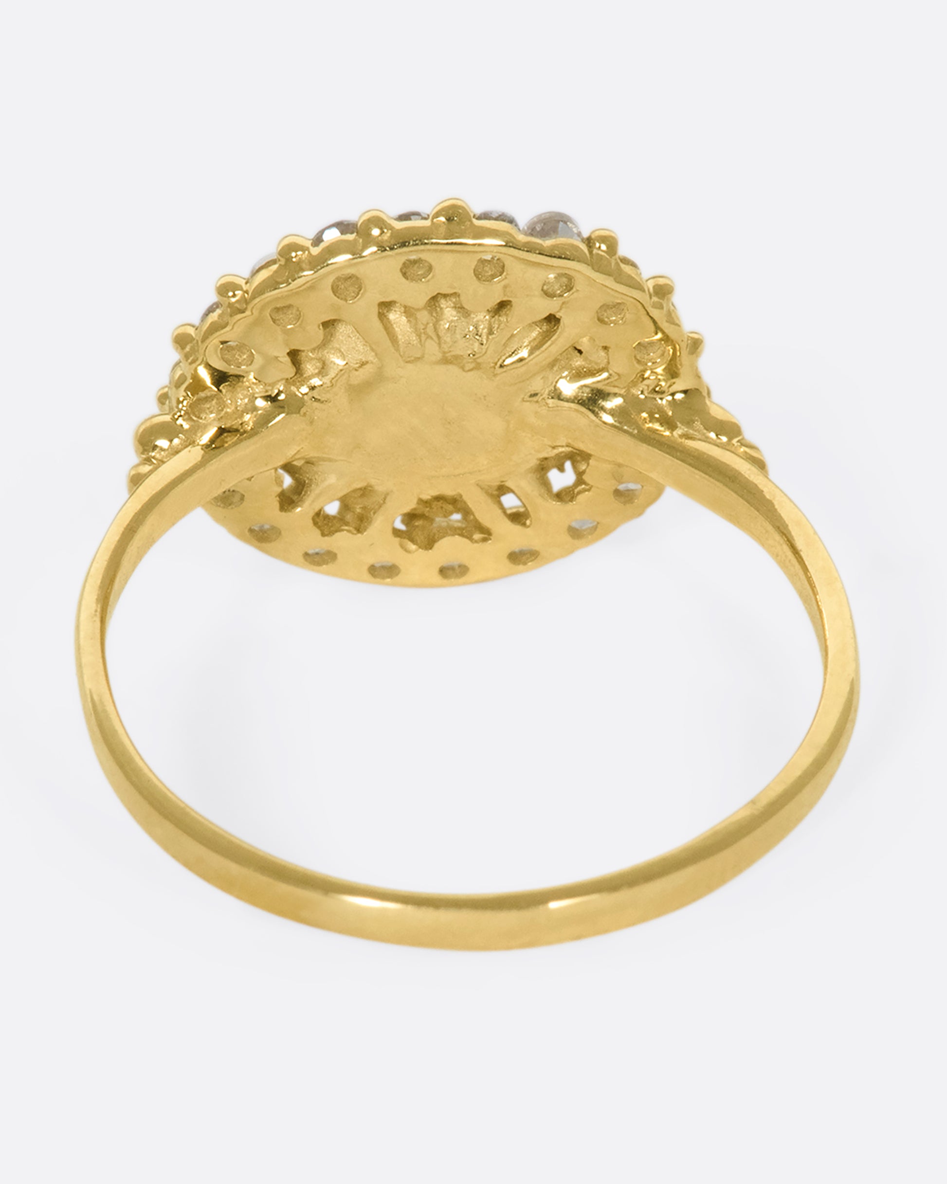 A 14k gold circle ring with a white diamond halo
