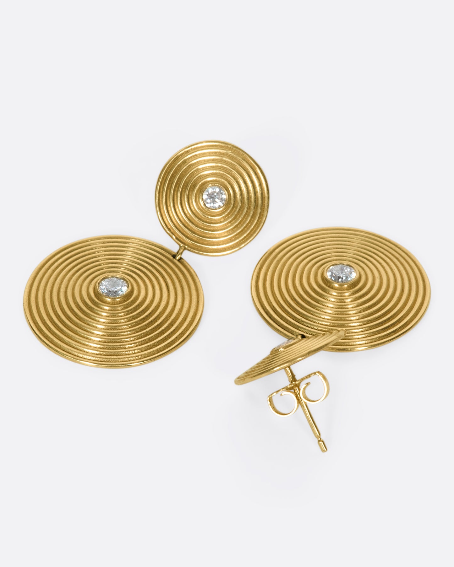 14k gold disc drops, each puntcuated with two white diamonds. The concentric circles are elegant symbols of growth and change.