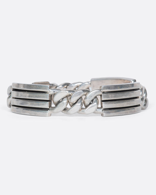 A vintage Mexican sterling silver bracelet with alternating ribbed segments and curb chain connections. It's heavy weight and unique design create a substantial presence on your wrist, solo or stacked.