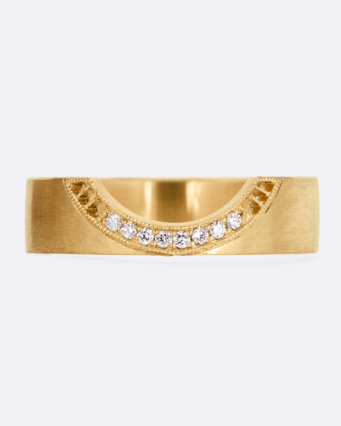 A yellow gold arched ring with eight bead set diamonds set above the half moon cutout at the center, shown from the front.