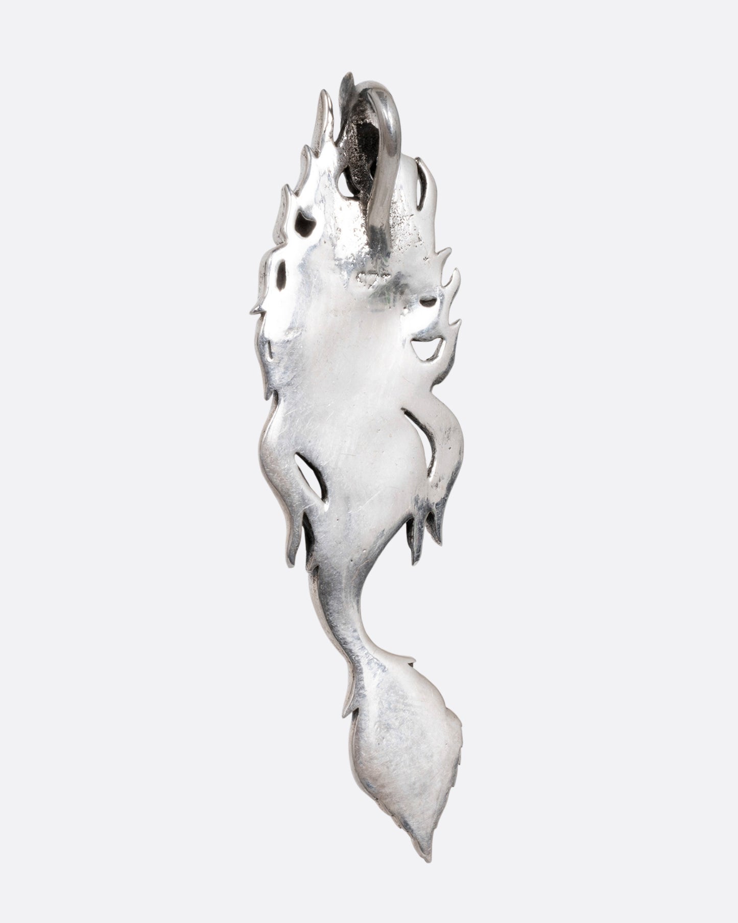 A silver mermaid pendant with abalone inlay on her tail, shown from the back.