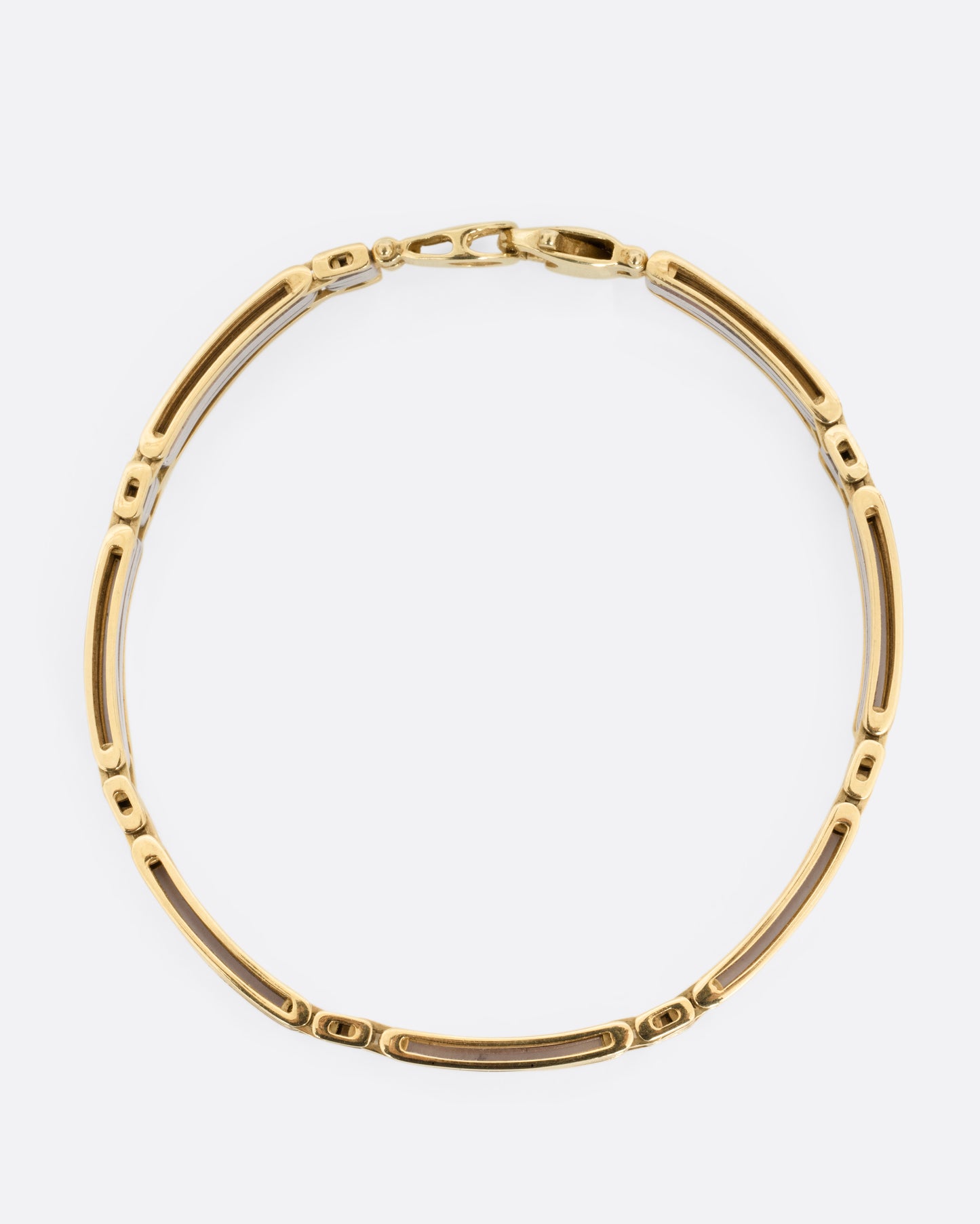 A yellow and white gold link bracelet, shown from the top.