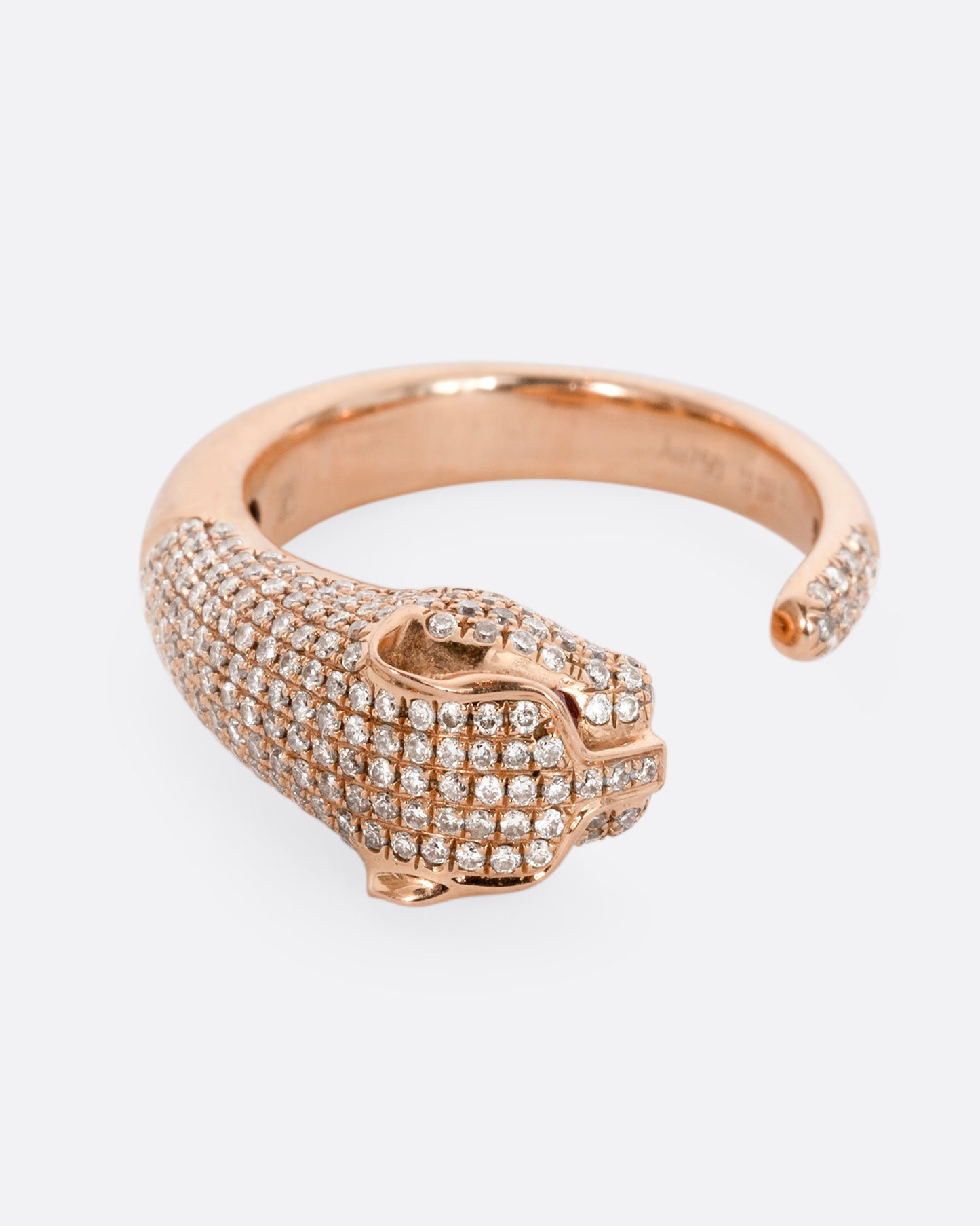 A rose gold panther wrap ring with pave diamonds on the head and tail and ruby eyes. Shown from the front.