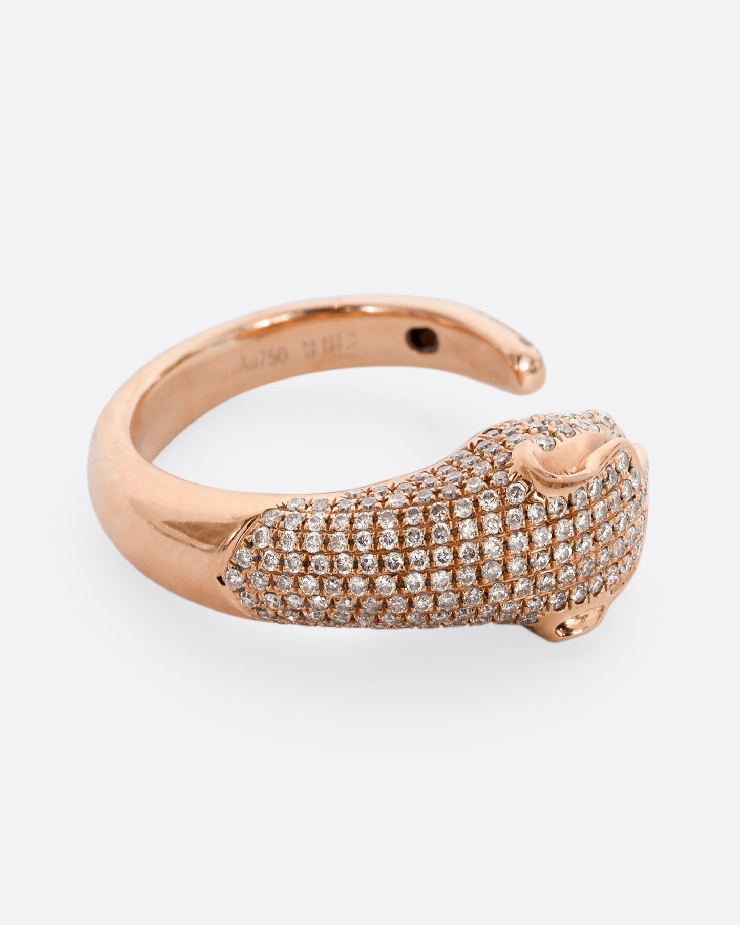 A rose gold panther wrap ring with pave diamonds on the head and tail and ruby eyes. Shown from the side.