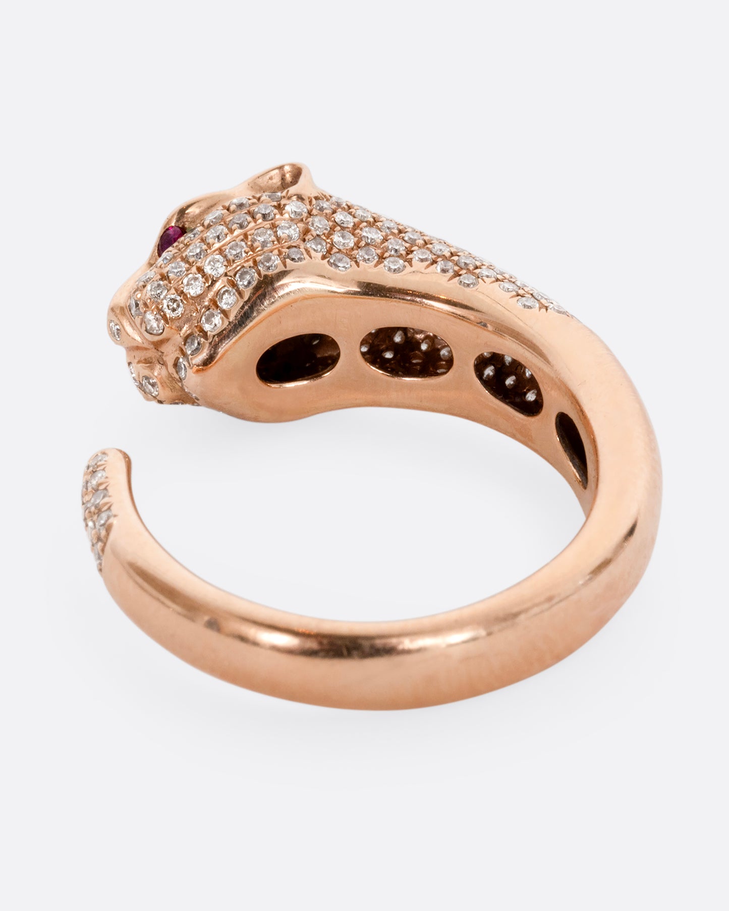 A rose gold panther wrap ring with pave diamonds on the head and tail and ruby eyes. Shown from the back.