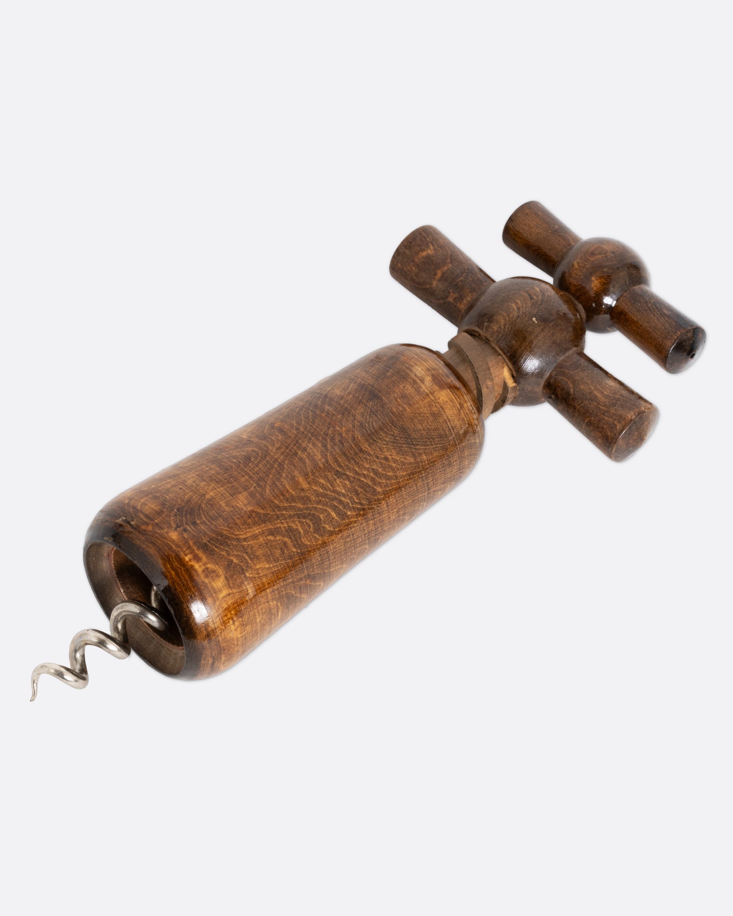 A wooden cork screw, shown from the bottom lying flat.