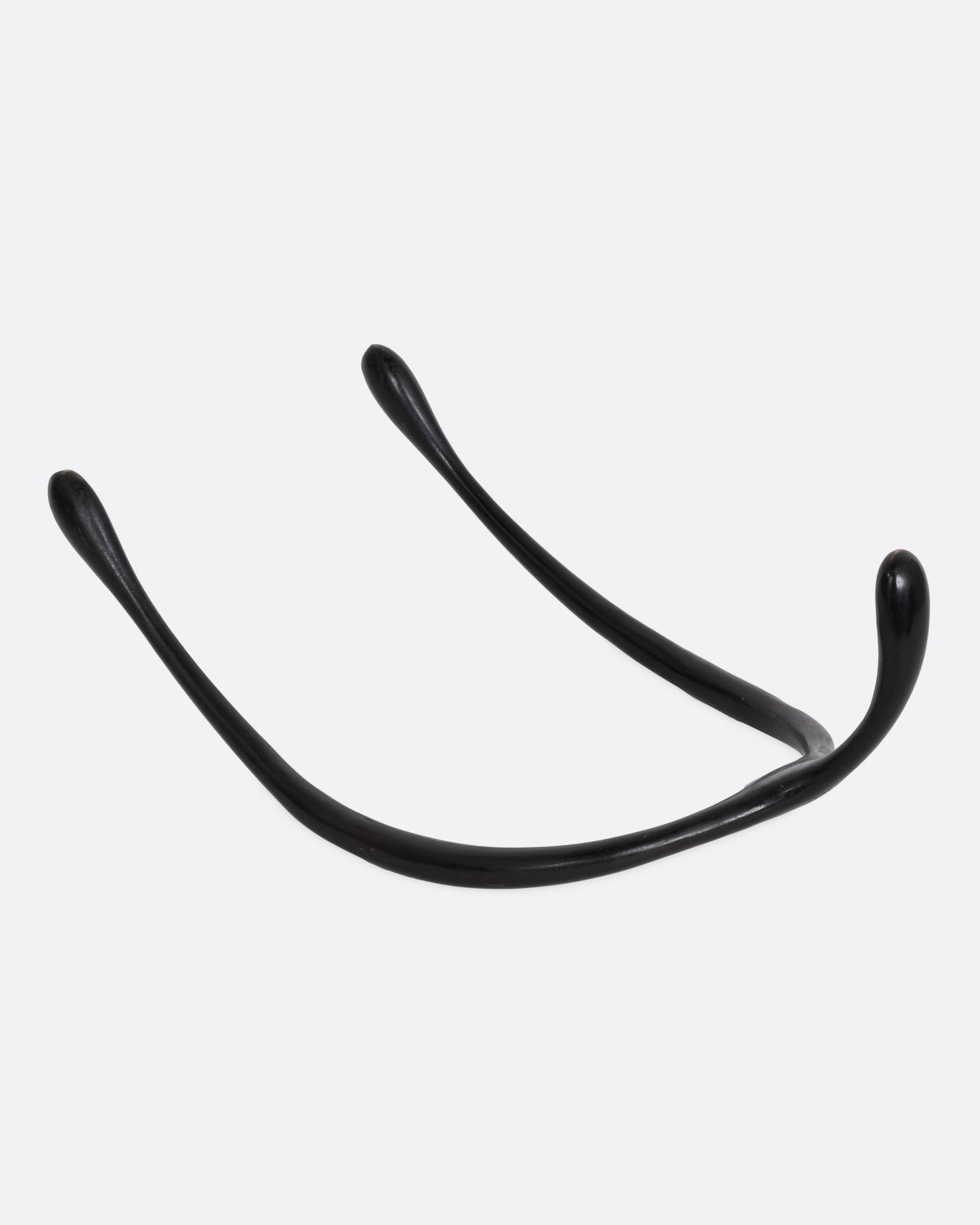 A black bronze wishbone sculpture, shown from the back.