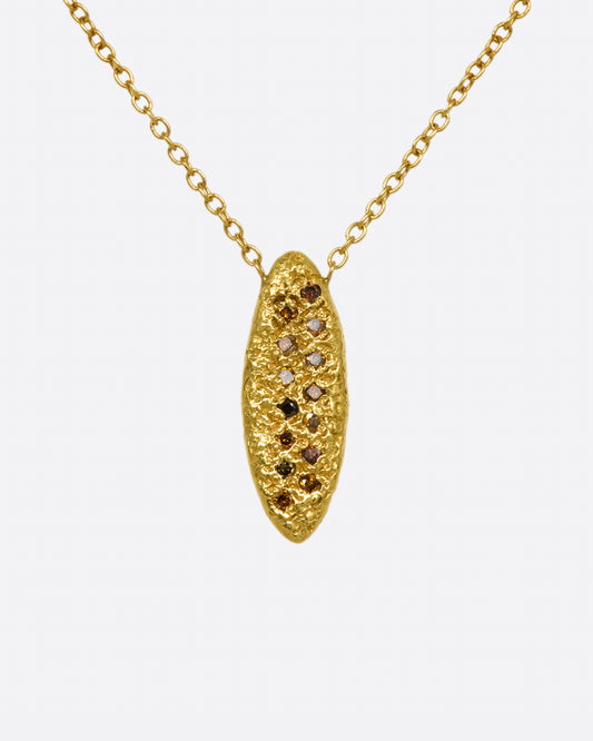 A yellow gold chain necklace with a marquise shape textured pendant, with two rows of red and brown diamonds.