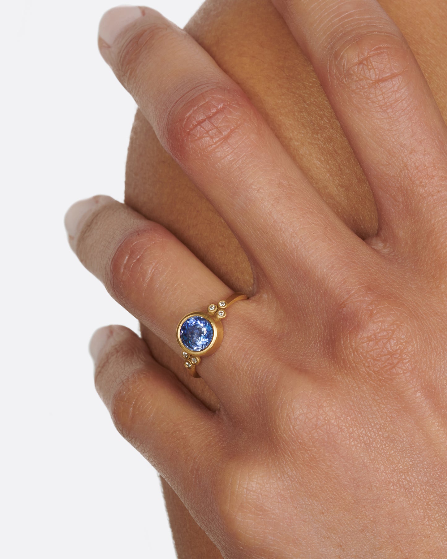 The stunning, periwinkle blue sapphire at the center of this ring is the star of the show.