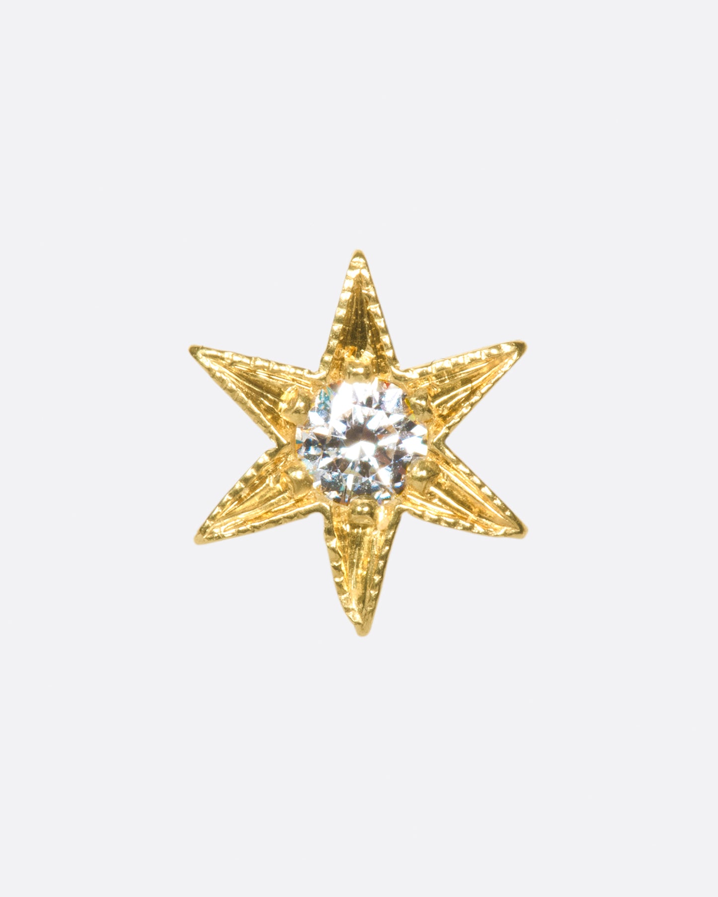 A yellow gold star stud earring with a central diamond and six points with millgrain details. Shown from the front.