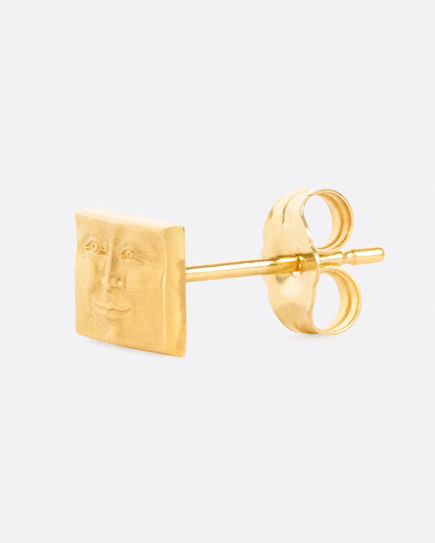 A tiny, smiling, rectangular face to adorn your ear.