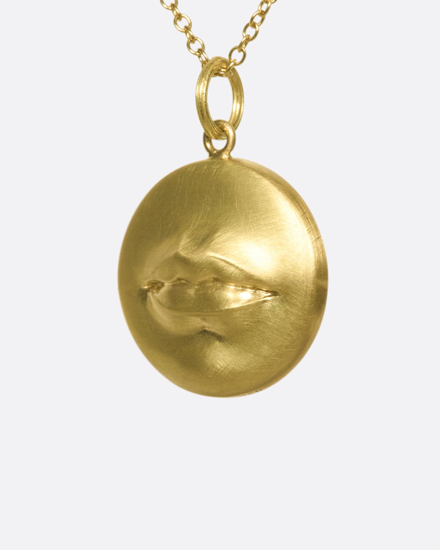 A solid, heavy pendant with a striking, sensual design with a sense of humor.