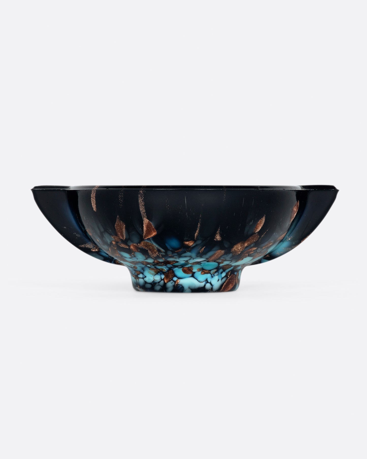 Speckled with metallic copper and bright aqua blue, no two of these hand blown ashtrays are exactly the same.