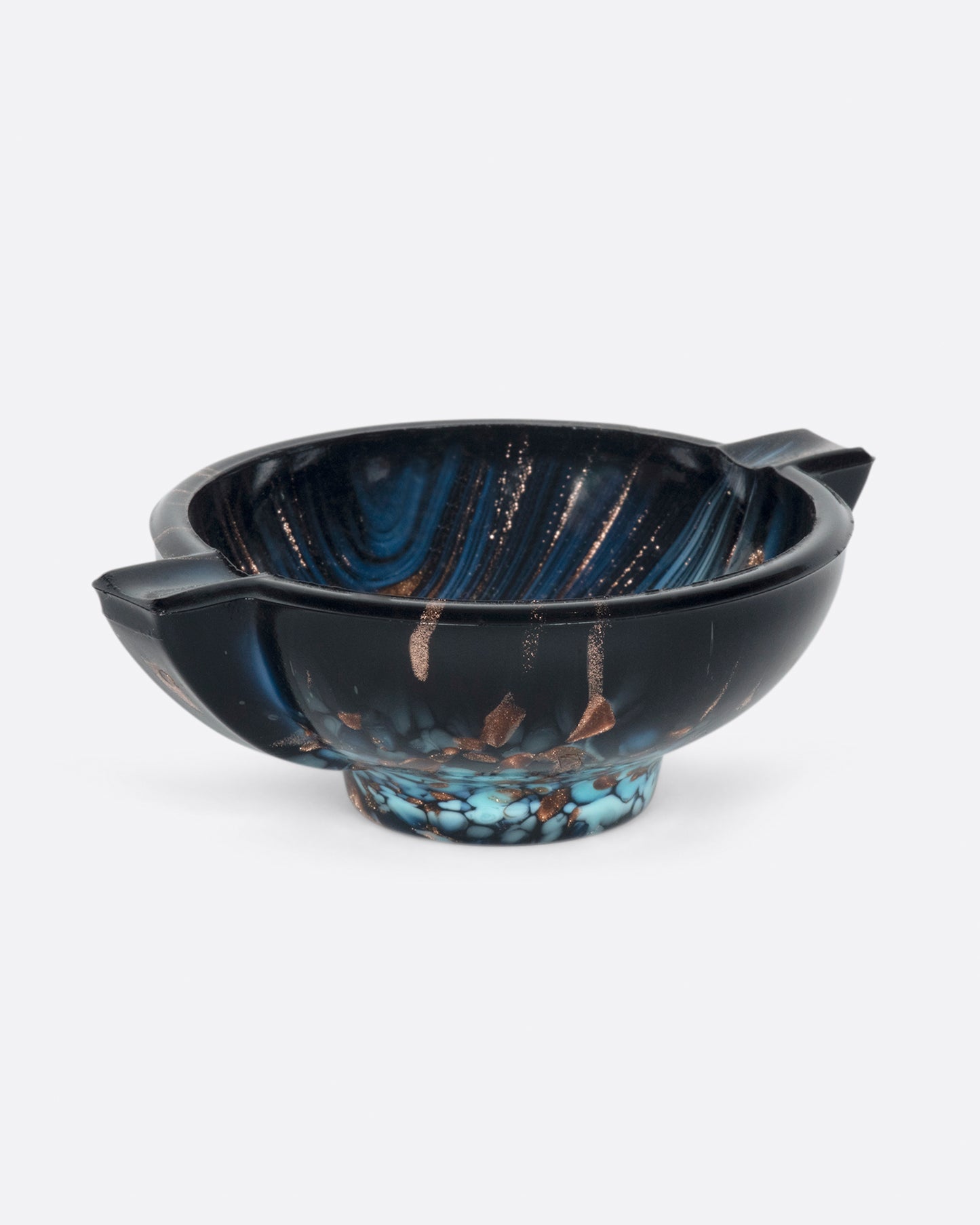 Speckled with metallic copper and bright aqua blue, no two of these hand blown ashtrays are exactly the same.