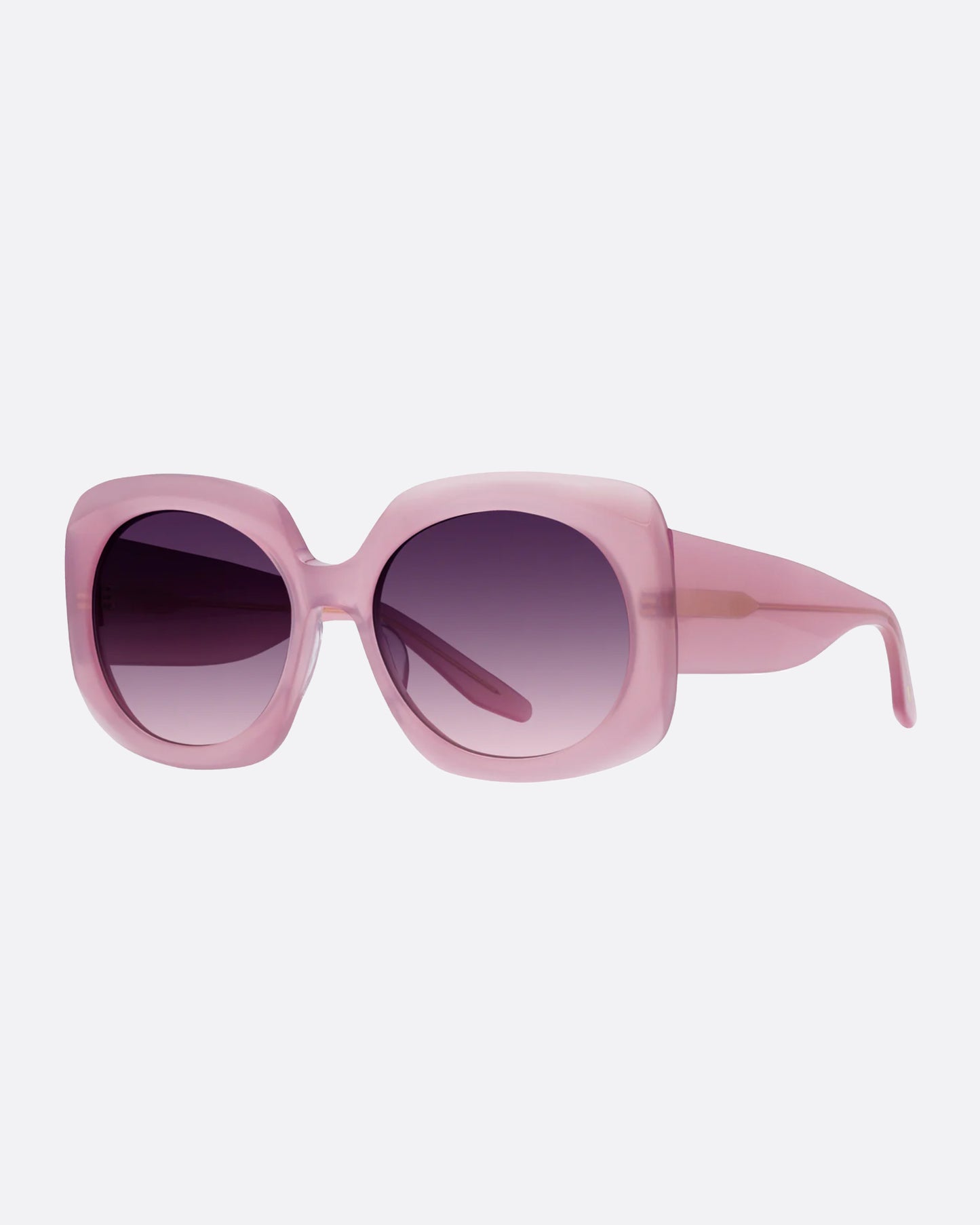 A pair of substantial frames with chic curves in a semi-transparent magnolia pink with gradient lenses.