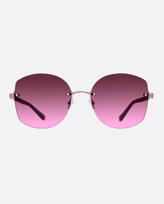 A pair of rose gold titanium frame sunglasses with pink cat eye lenses.