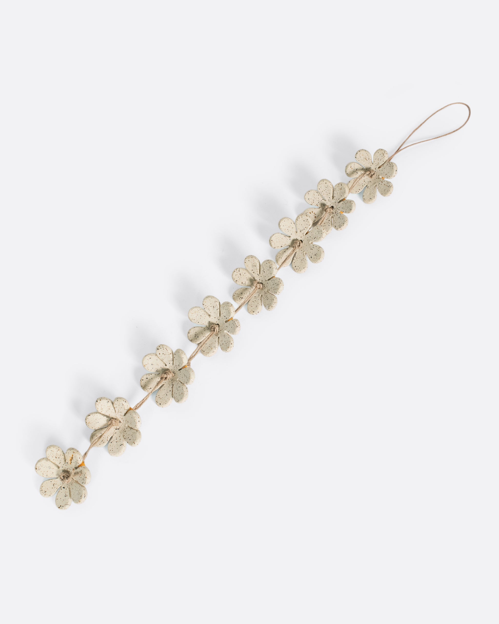 This daisy chain ceramic garland adds a burst of sunshine to any corner, window, or kids room. They look especially sweet hanging in a cluster like a mobile over a crib.
