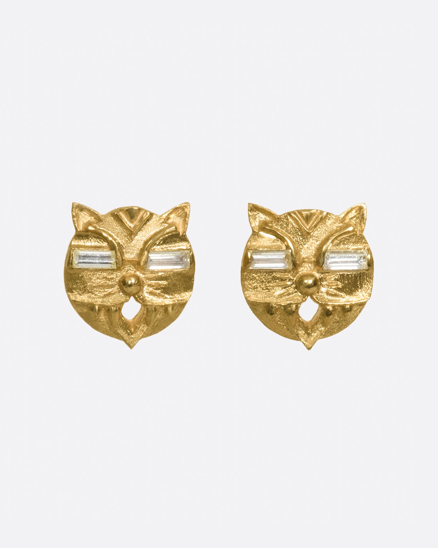 A pair of lucky cat earrings with glowing diamond eyes.