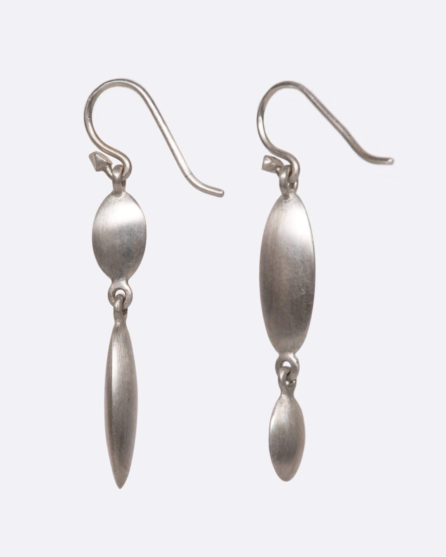 These asymmetrical dangles juxtapose a flat circle with a razor-thin oval in a luscious matte finish