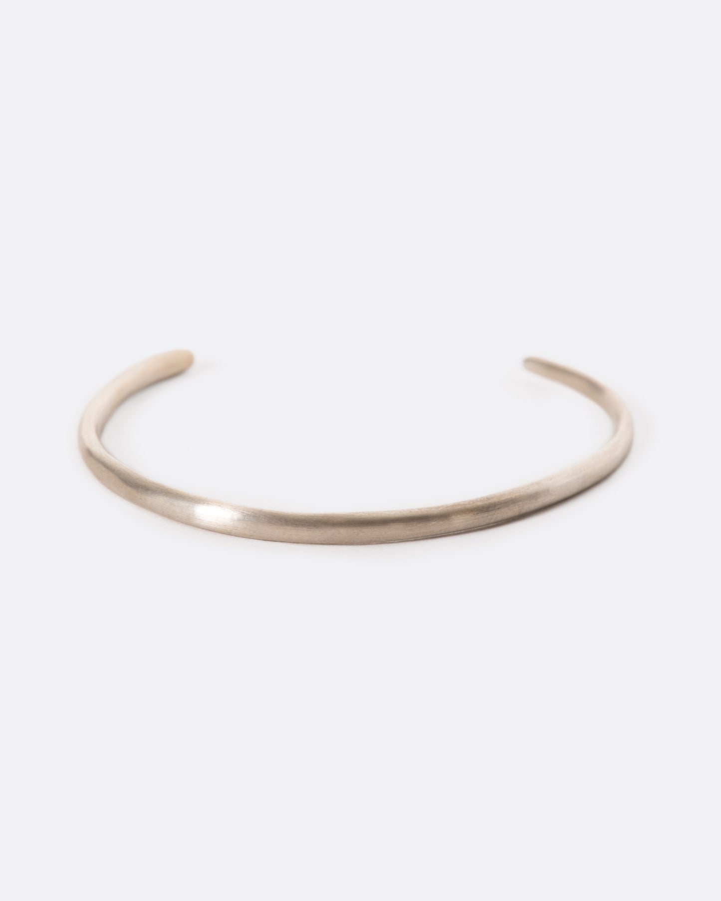 An asymmetrical cuff whose opening sits to the side of your wrist; wear it with the opening facing up or down.