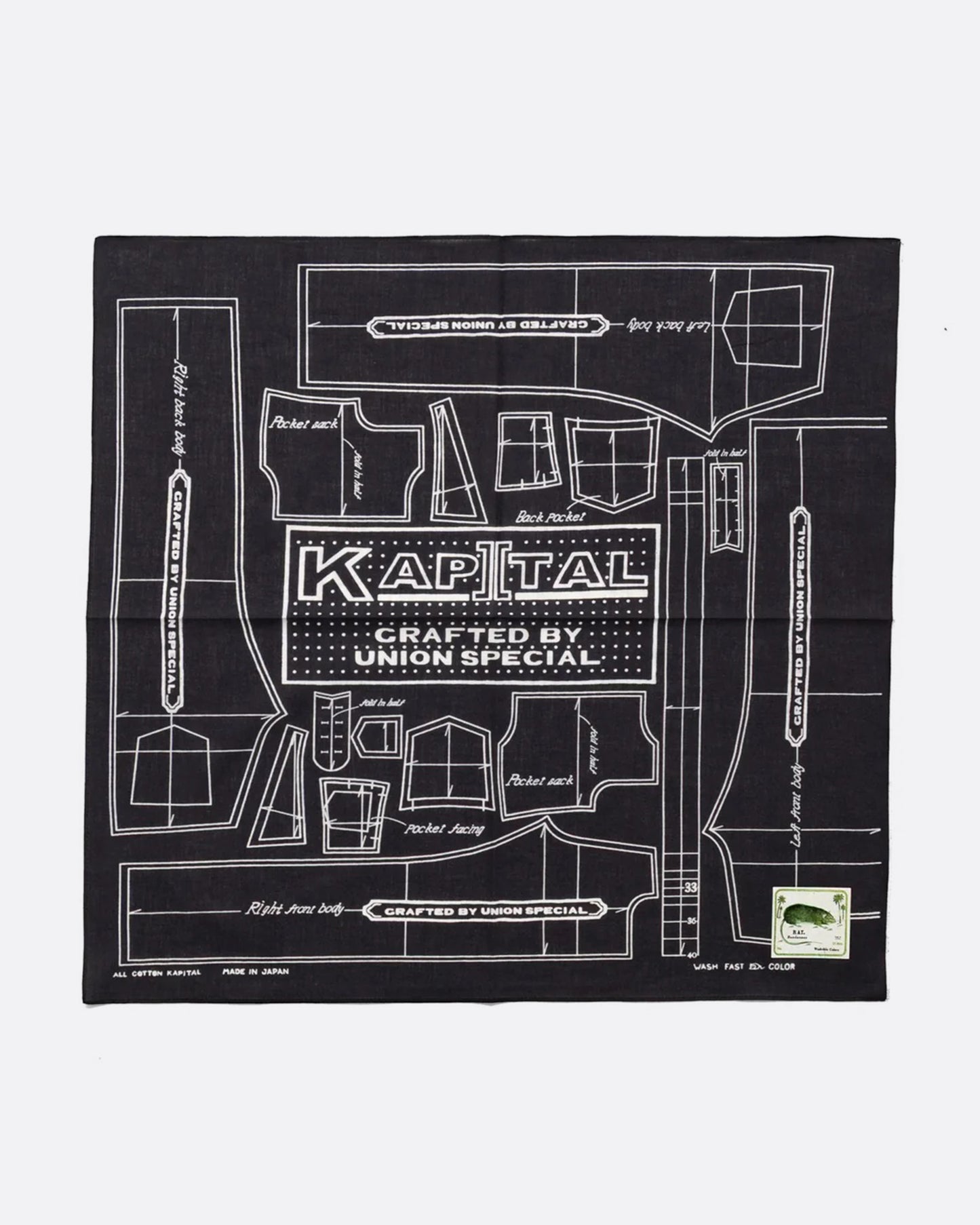 A black cotton bandana with a pattern for a Barbie sized outfit in white and 'KAPITAL CRAFTED BY UNION SPECIAL' at the center. Shown from the front.