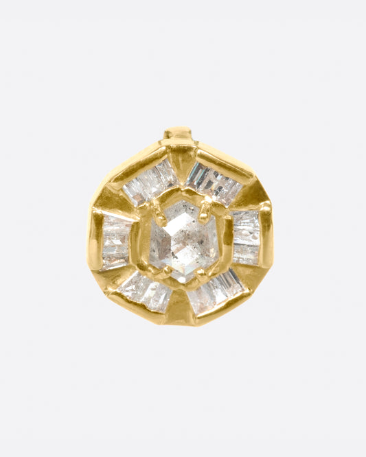 An alternative to a classic medal, this round pendant has a rose cut diamond at its center and is lined with baguettes.