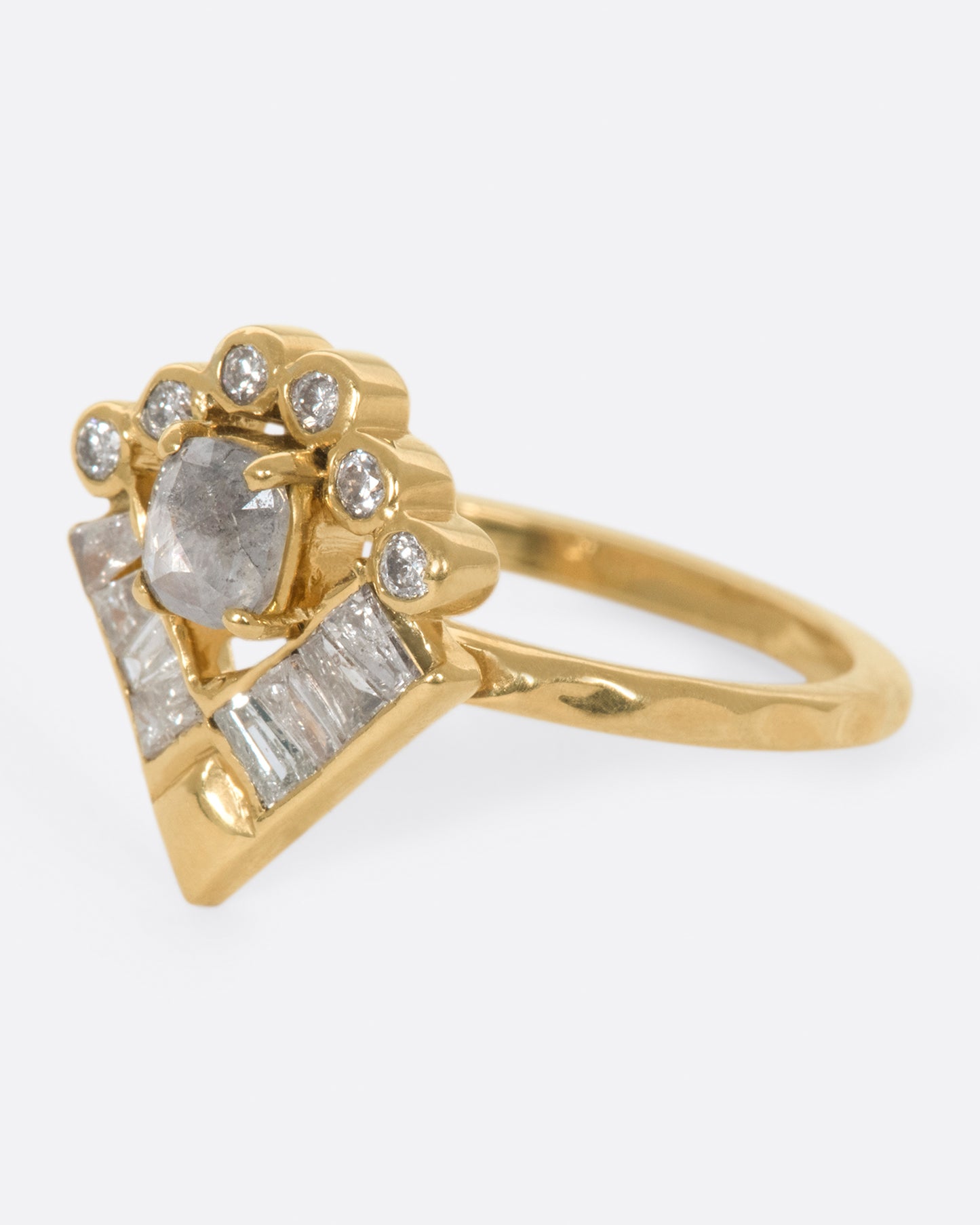A ring that encompasses a little bit of everything; geometry, a halo, a textured band, round and baguette diamonds, and an oval rose cut salt & pepper diamond at its center.