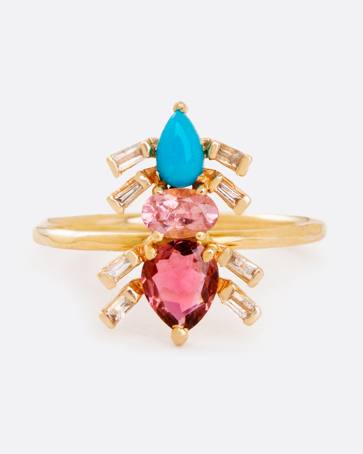 A yellow gold ring pink tourmalines, turquoise, and baguette diamonds in the shape of an ant. Shown from the front.