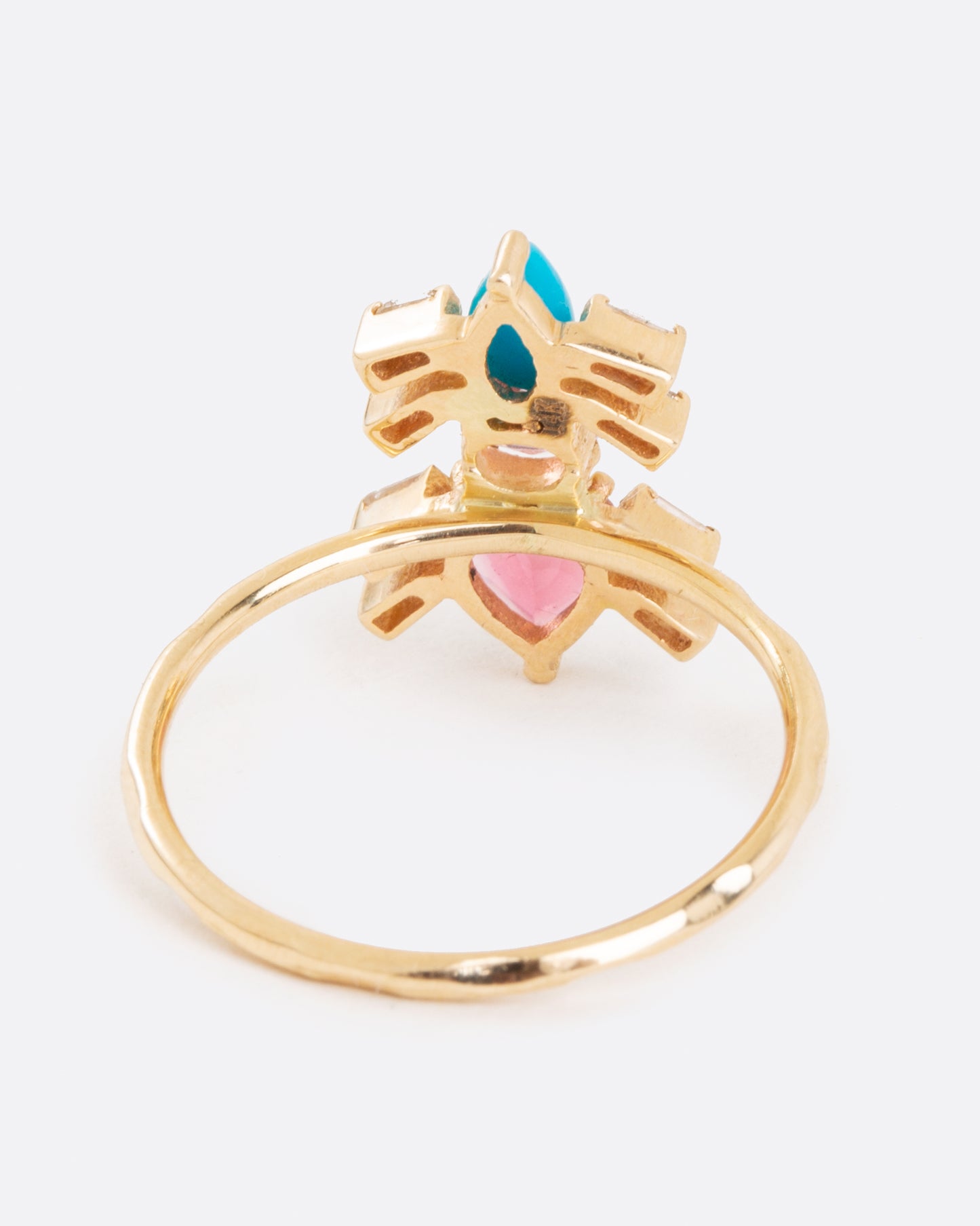 A yellow gold ring pink tourmalines, turquoise, and baguette diamonds in the shape of an ant. Shown from the back.