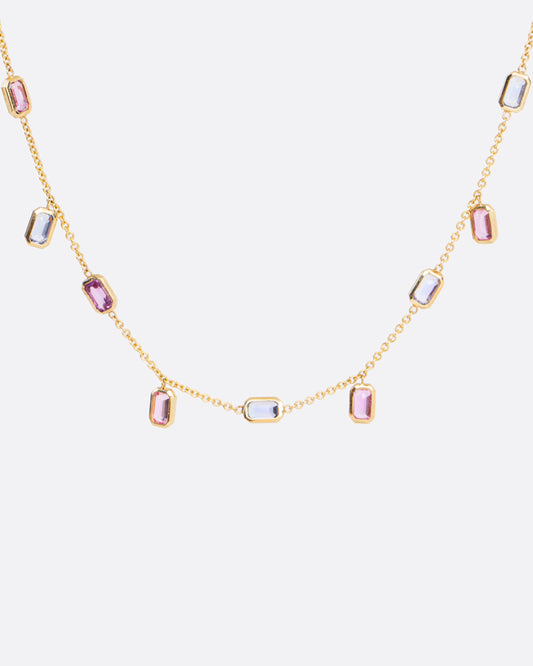 A chain necklace with alternating fixed and floating bezel set sapphires. With a mix of sapphire colors this necklace is fun with a touch of elegant.