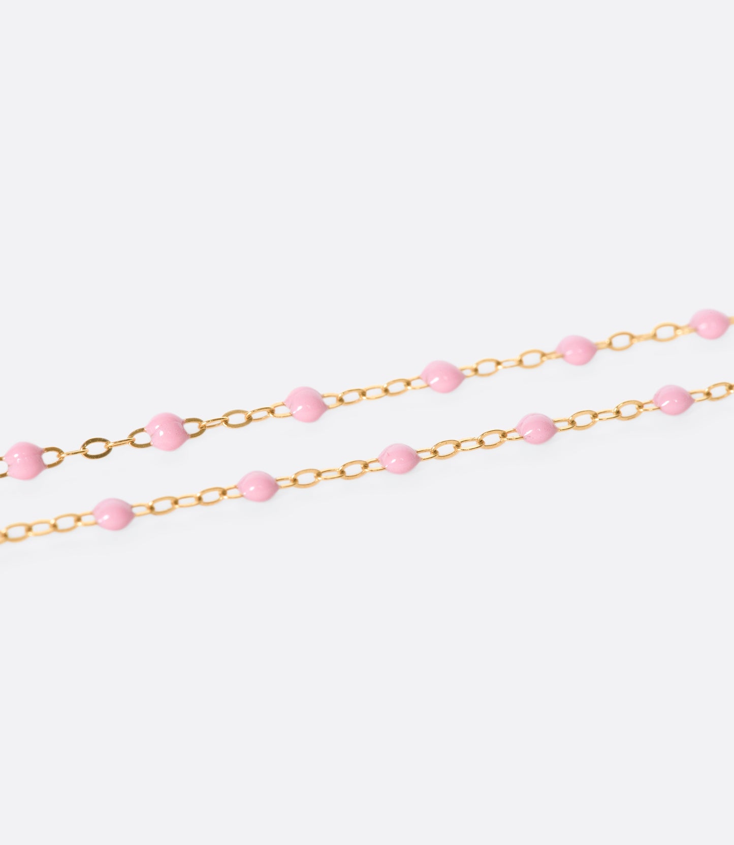 A thin rose gold chain necklace with resin beads. Each necklace is hand dipped in melted resin to create the beaded effect. 