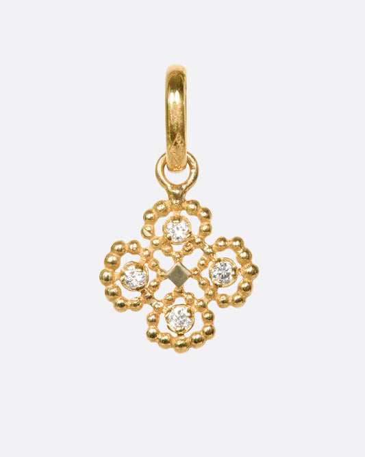 An 18k yellow gold clover pendant with round diamond details
