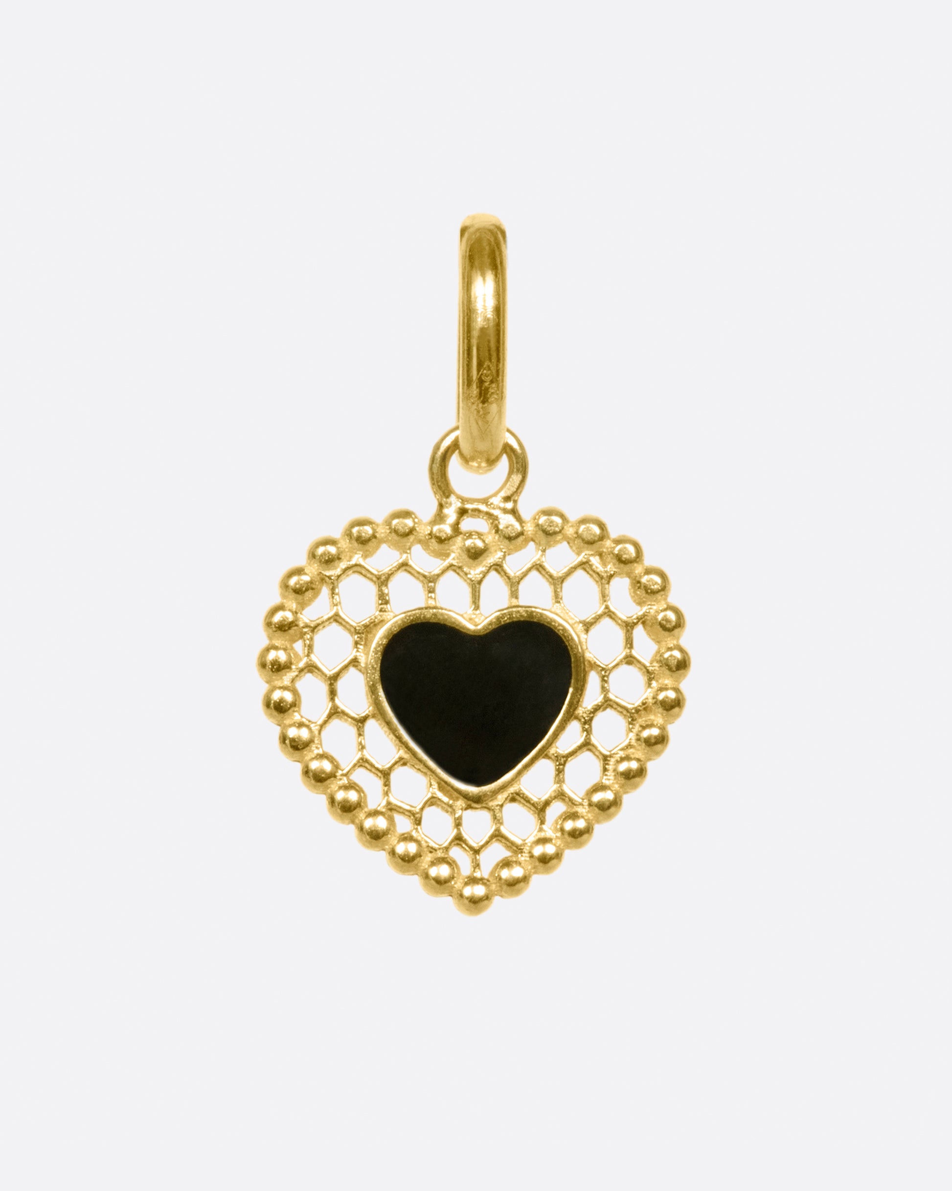 A vintage inspired heart charm that's still cool and new with its cutout details.