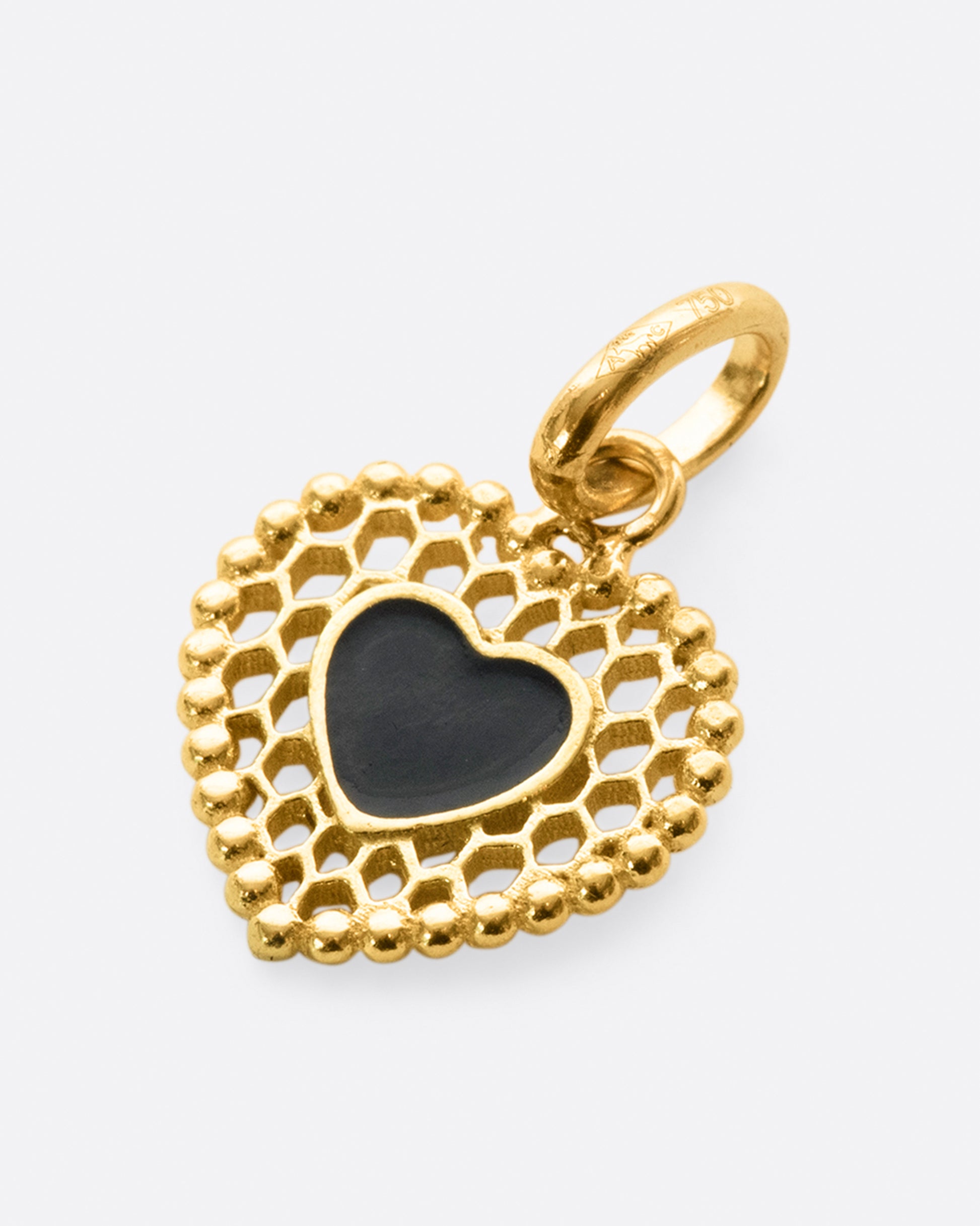A vintage inspired heart charm that's still cool and new with its cutout details.