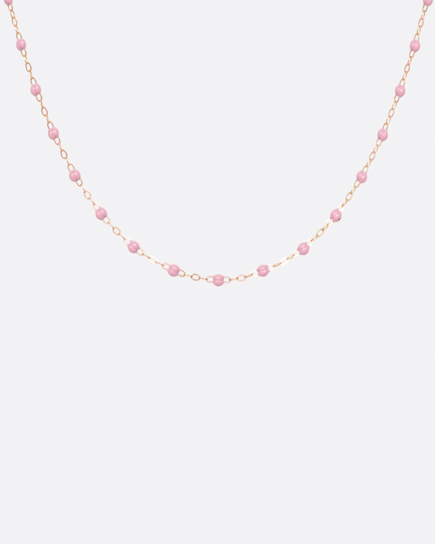 A thin rose gold chain necklace with resin beads. Each necklace is hand dipped in melted resin to create the beaded effect.