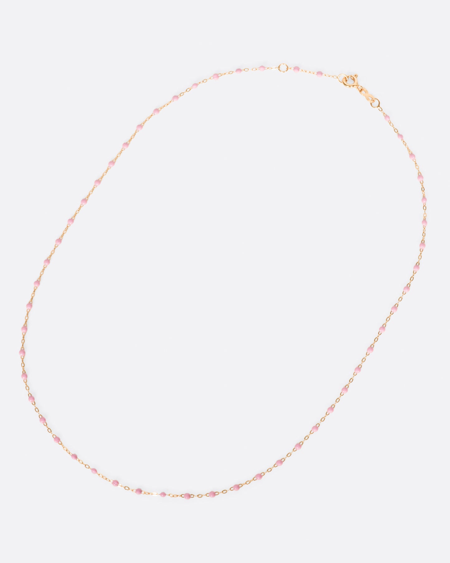 A thin rose gold chain necklace with resin beads. Each necklace is hand dipped in melted resin to create the beaded effect.