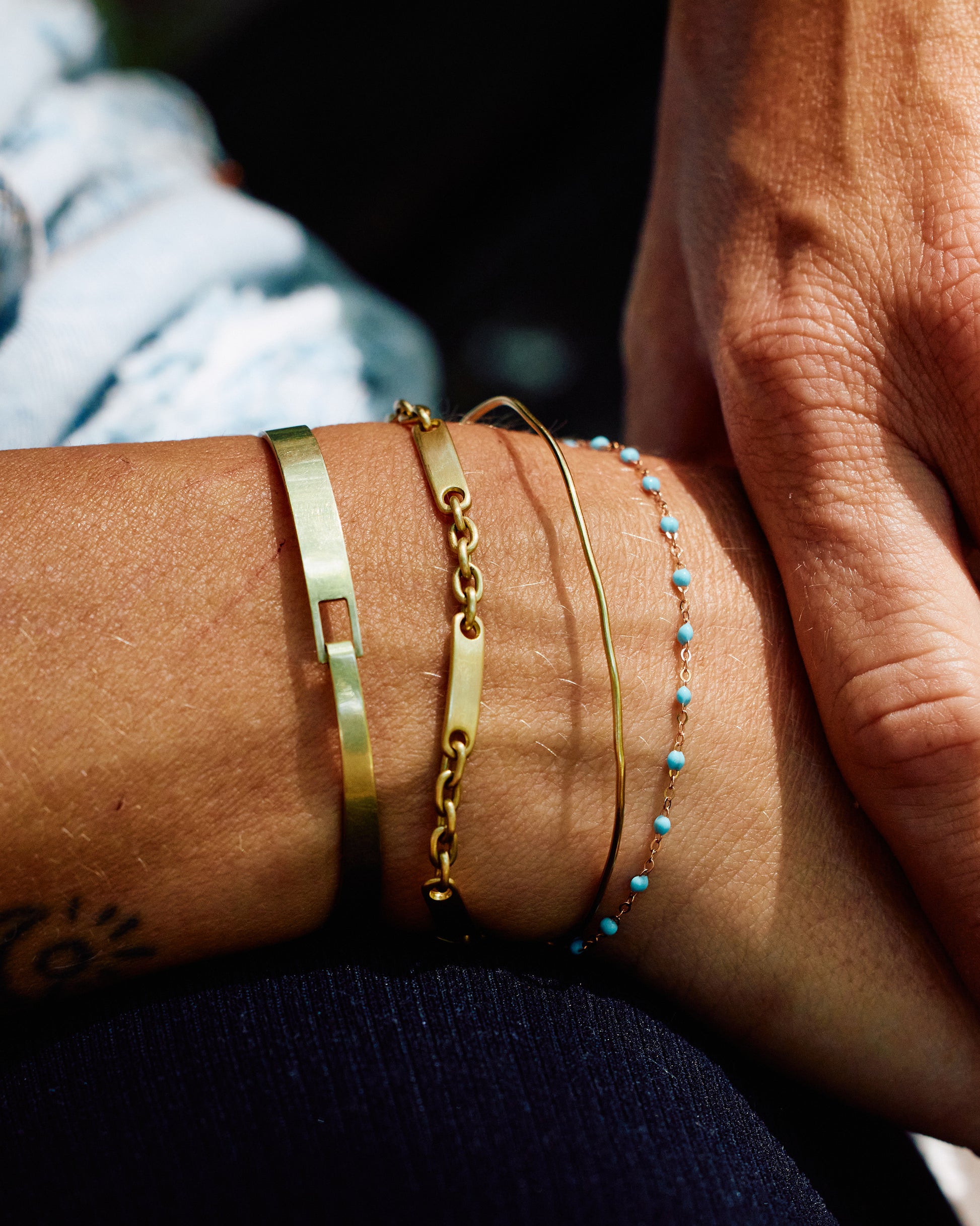 Thin yellow gold chain bracelet with resin beads. Each piece is hand dipped in melted resin to create the beaded effect.