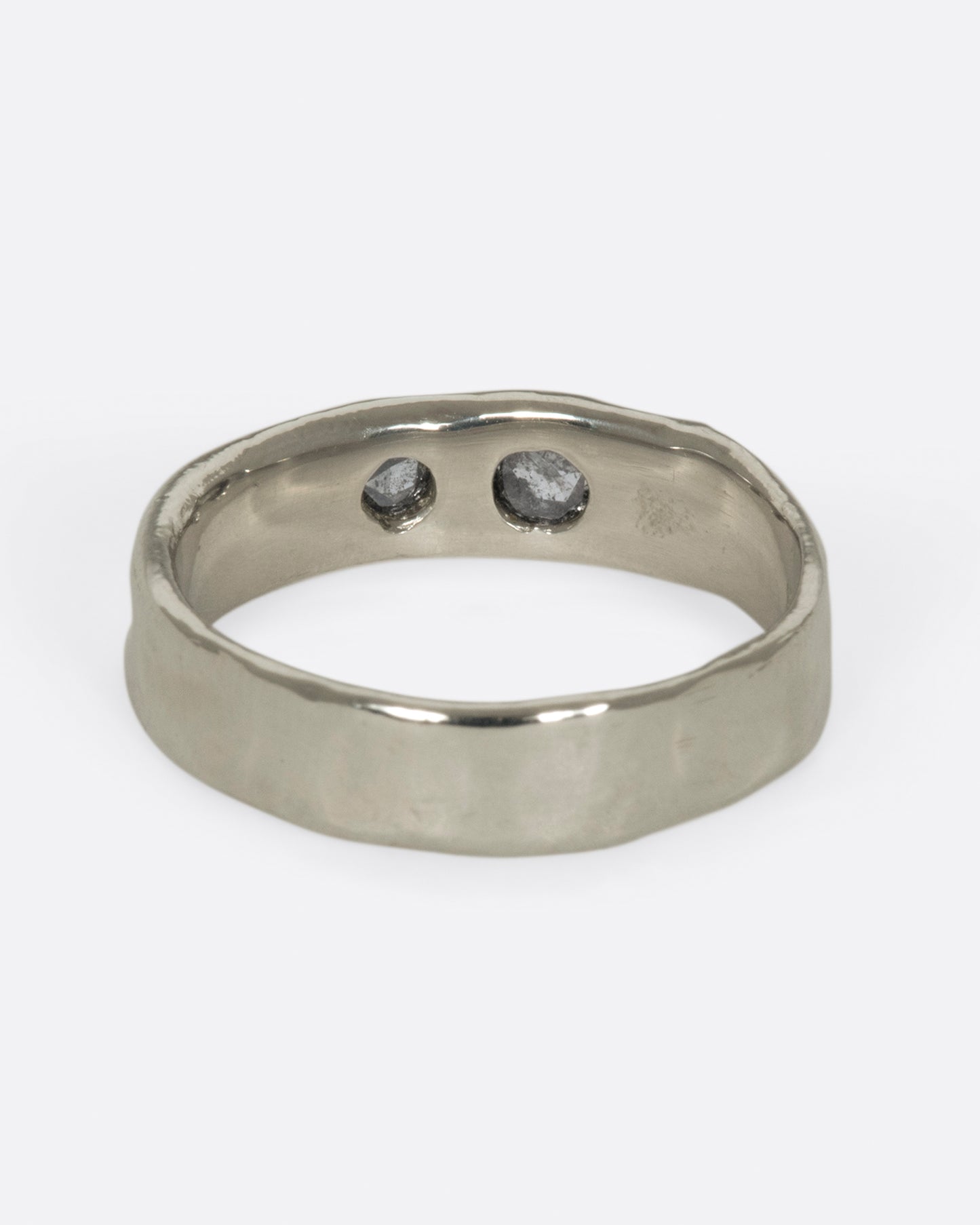 Medium wide band with light texture, featuring two rose cut salt & pepper diamonds flush to the band.