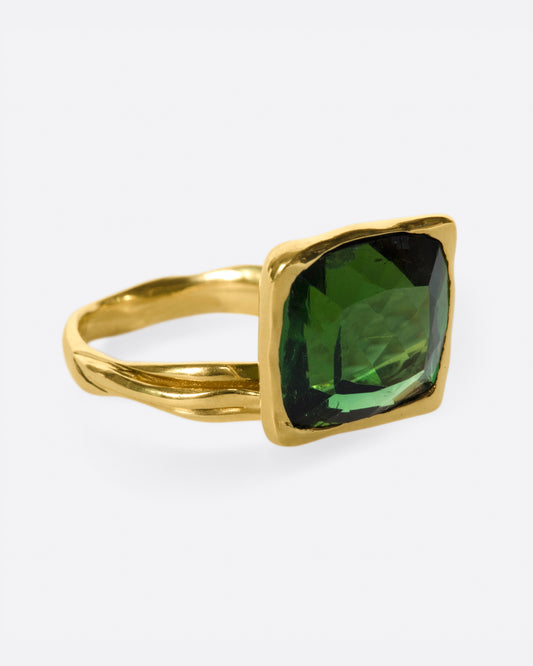 This ring is designed to showcase the tourmaline; the band is set off to one side and the setting is raised to allow for maximum light to pass through the stone.