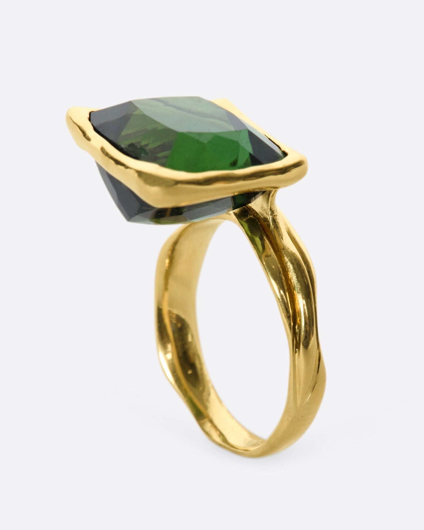 This ring is designed to showcase the tourmaline; the band is set off to one side and the setting is raised to allow for maximum light to pass through the stone.