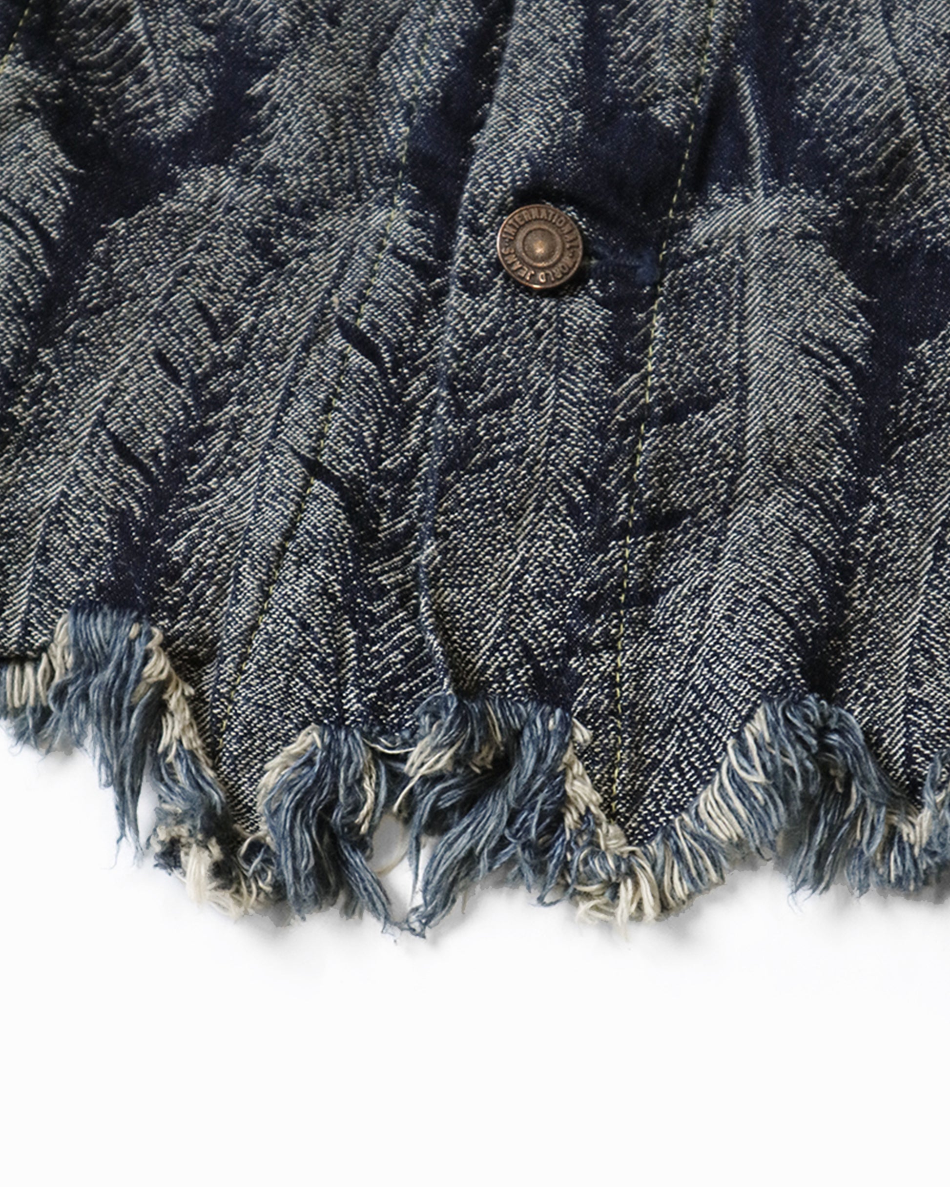 A Type III jacket made from denim jacquard with a 3D luxurious feather pattern and a fringy hem.