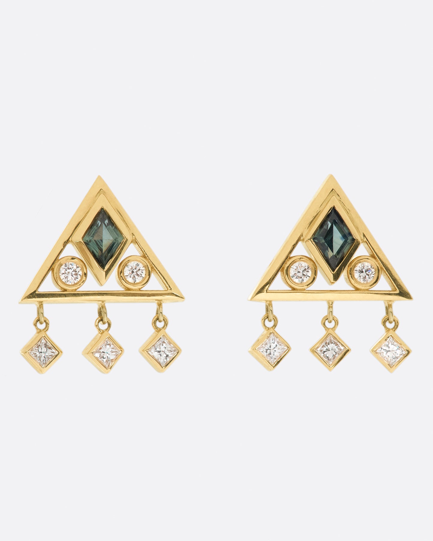 A gorgeously geometric pair of 14k gold triangle studs with teal sapphire lozenges and diamond accents