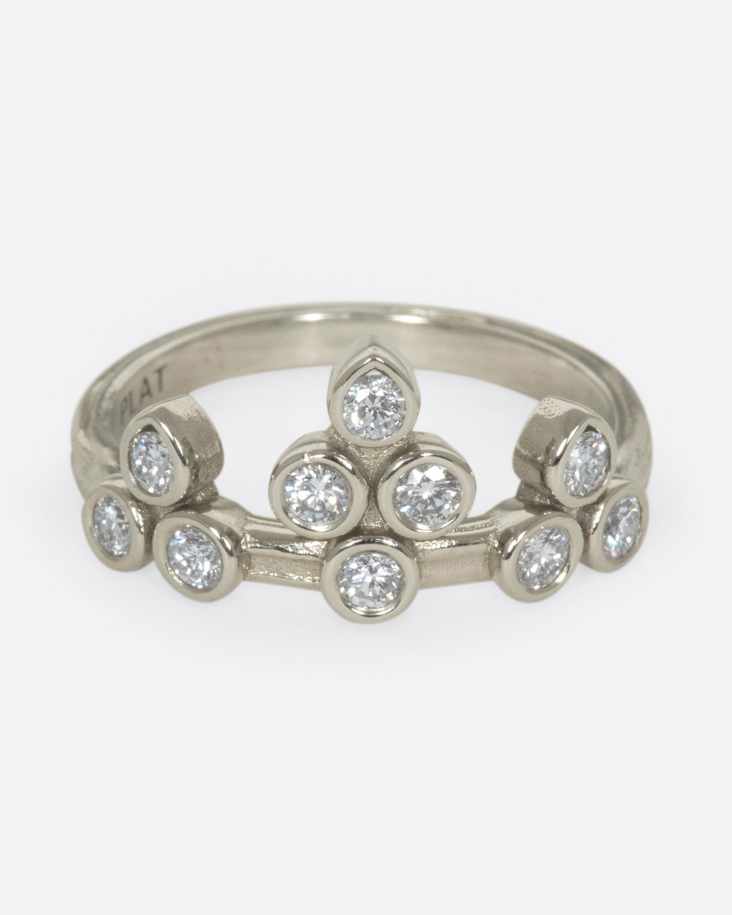 A tiara-like ring formed by 10 bezel-set round diamonds; wear it alone or stacked, and in either direction on the finger.