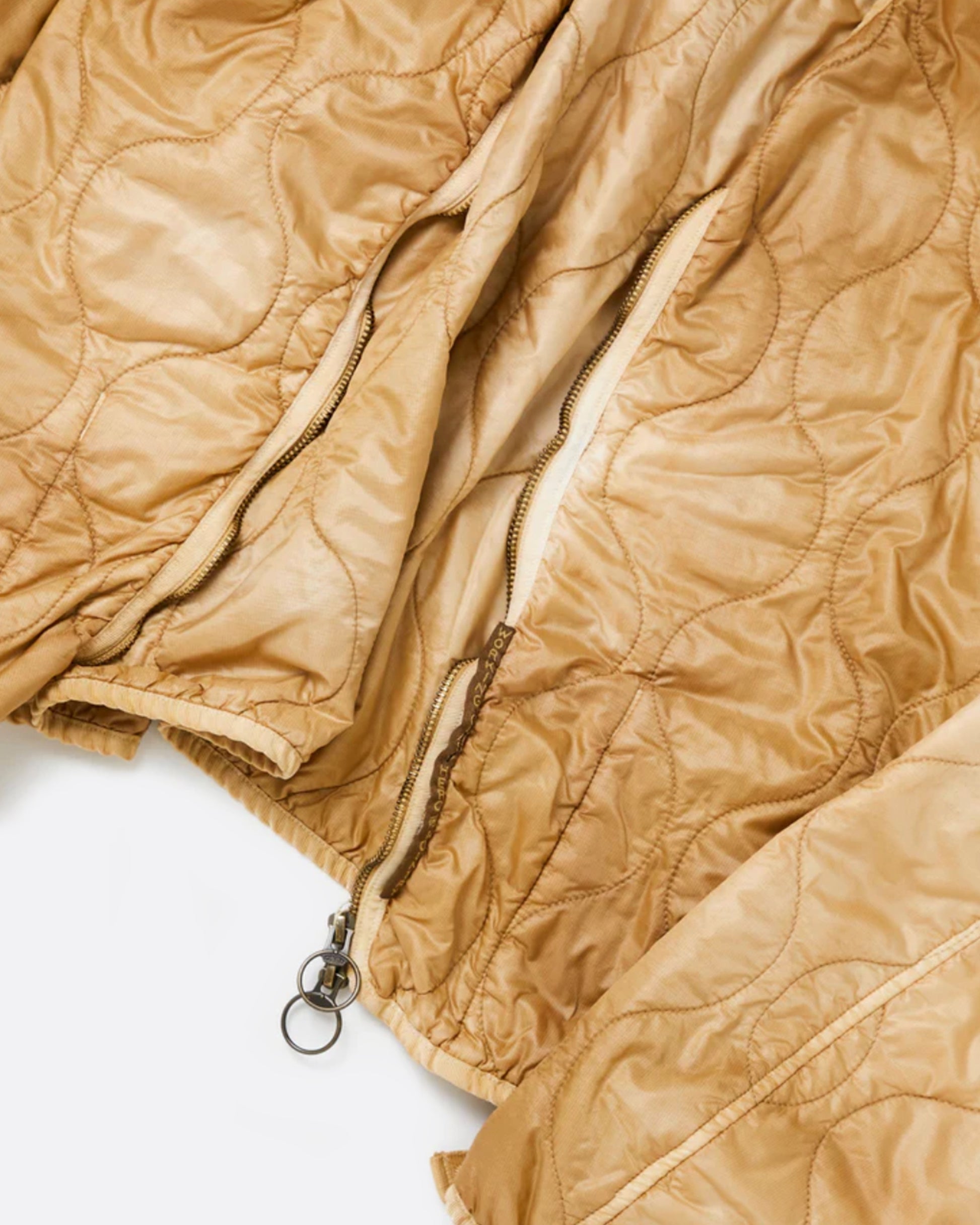 A nylon, quilted, dip-dyed bolero jacket in a golden brown - great for layering!