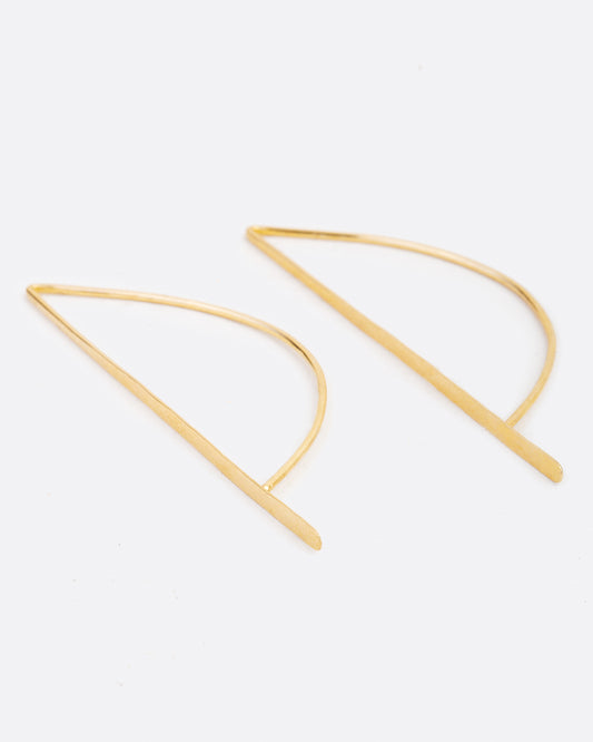 Called the bow hook earrings, this unusual shape is a unique take on a hoop earring with a flat edge that catches the light.