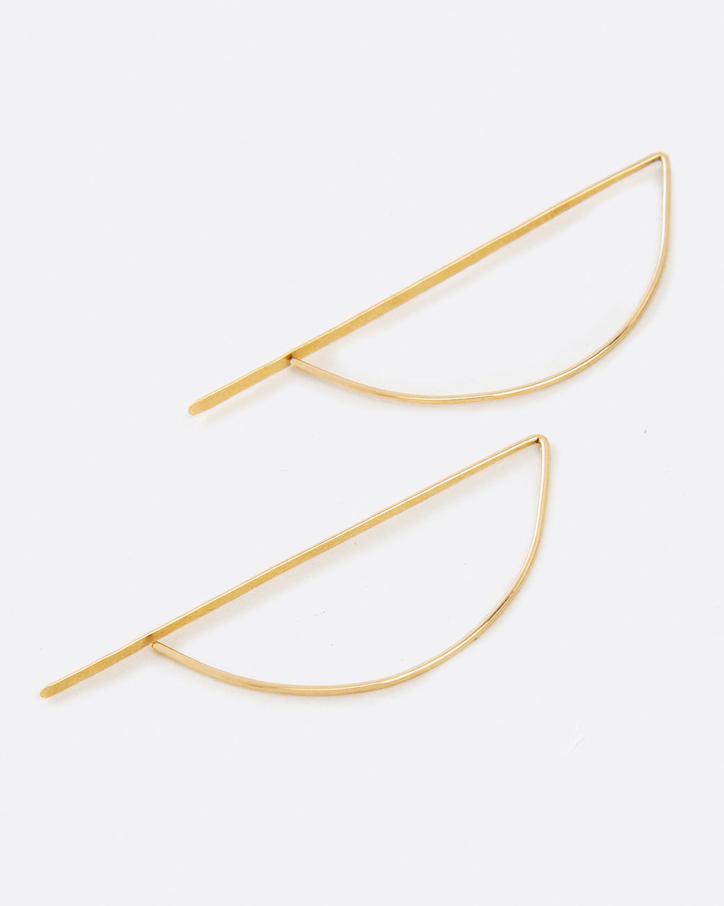 Called the bow hook earrings, this unusual shape is a unique take on a hoop earring with a flat edge that catches the light.
