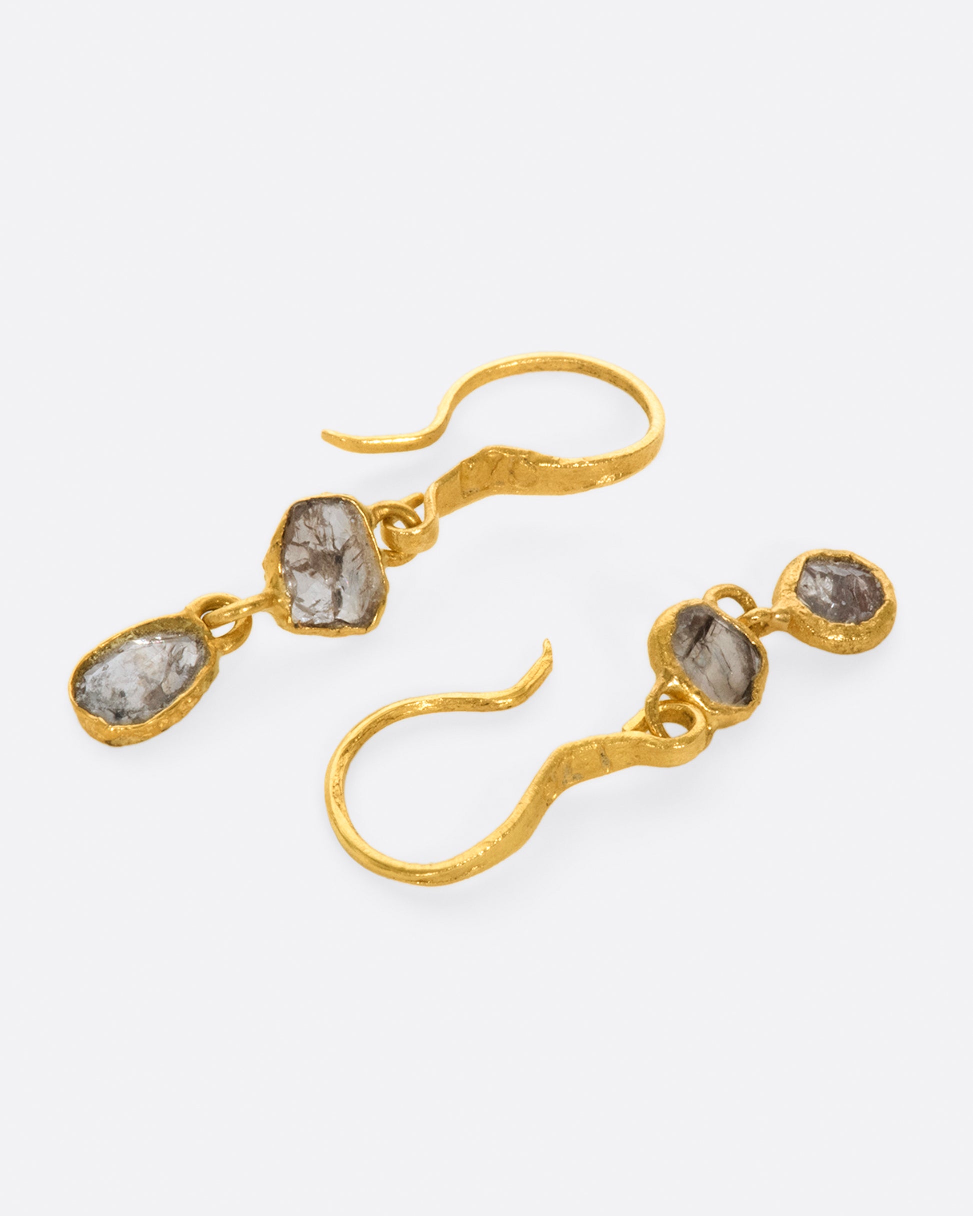 These natural grey Borneo diamond drops are wrapped around their edges in 22k gold, so you can see the unique, asymmetrical stones from both sides.